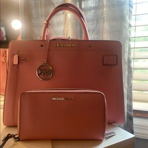 Pink Michael Kor handbag with crossbody strap.